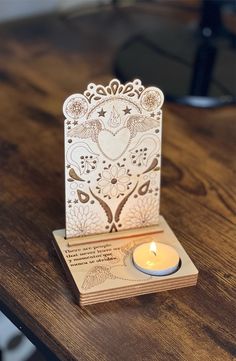 a card with a lit candle sitting on top of it