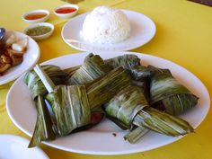 some food is on a white plate and yellow tablecloths are around the plates