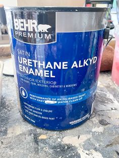 a blue paint bucket sitting on top of a table