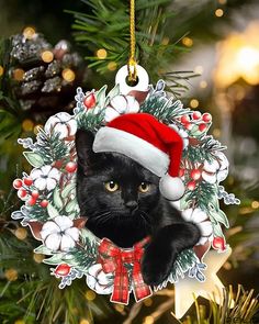 a christmas ornament with a black cat wearing a santa hat