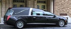 a black car parked in front of a building