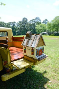 an old truck with a bird house on the back