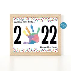 a wooden frame with a handprint on it that says 22 22 happy new year