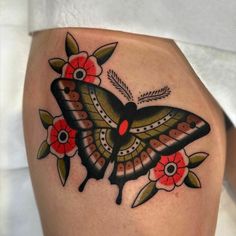 a close up of a butterfly with flowers on it's back leg and shoulder