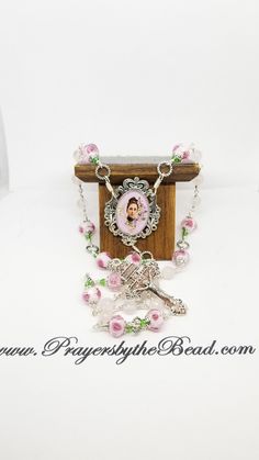 "Chaplet of St Therese Little Flower of Jesus, wire wrapped into a seamless display of gems, lampwork glass and custom created rosary pieces hand crafted by religious hands exclusively for this ministry shop, Prayers by The Bead. A lovely custom colored enameled pink crucifix begins this chaplet. Faceted rose quartz and silver foil Rose Lampwork begins the prayer journey, silver tone twist connector links completes this circle of prayer. This chaplet of 25 beads has both gemstones and artisan pi Handmade Adjustable Rosary For First Communion, Spiritual Gift Wire Wrapped Rosary, Spiritual Wire Wrapped Rosary As Gift, Confirmation Party, St Therese, The Prayer, Rosary Catholic, Silver Foil, Rosary