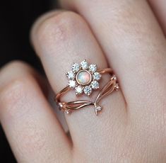 A colorful nature inspired opal and diamond flower ring with a round 4mm genuine Australian opal and a halo of white diamonds. Perfect as a unique floral engagement or wedding ring in 14k or 18k solid gold or platinum, here pictured in rose gold. The design can be made with gemstones of your choosing. If you would prefer other gemstones instead of diamonds/opals or a custom design, please contact us before purchase. Item details Main gemstone: genuine round Australian opal Measurements: approx. The Bling Ring, Opal Diamond Ring, Rose Engagement Ring, Diamond Flower, Halo Diamond Ring, Australian Opal, Sapphire Engagement, Rose Gold Engagement Ring, Engagement Rings Sapphire