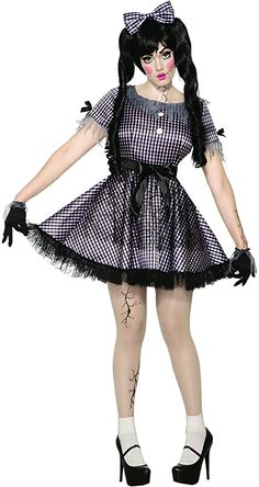 a woman dressed in a costume with black and white checkered dress, tights and high heeled shoes