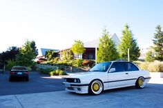 a white car parked in front of a house