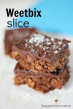 two chocolate brownies stacked on top of each other with the words weetbix slice above them