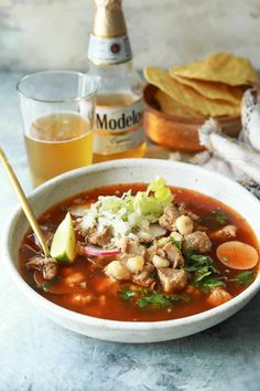 a white bowl filled with meat and vegetable soup