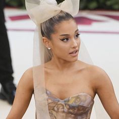 a woman in a wedding dress with a veil on her head