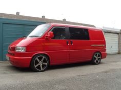 a red van parked in front of a garage