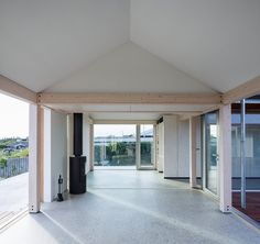 an empty room with large windows and doors on either side of the room is shown