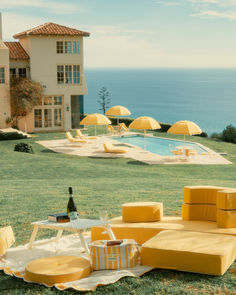 A luxurious outdoor setup featuring the Patio Umbrella, showcasing a nostalgic coastal European design. The umbrella’s high-quality materials, including stainless steel, aluminum, and teakwood, ensure durability and elegance, making it perfect for withstanding daily use in both commercial and residential settings. Beach Sofa, Pillow Stack, Folding Picnic Table, Beach Table, Bench Pillows, Beach Tent, Picnic Set, Wine Glass Holder, Read A Book