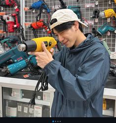 a man is holding a drill in his hand