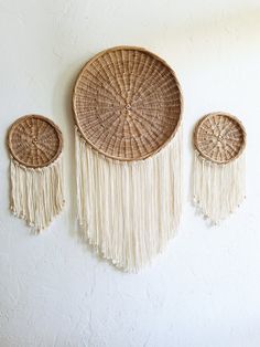 three woven baskets hanging on the wall