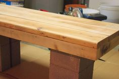 a bench made out of wood sitting on top of a hard wood flooring area