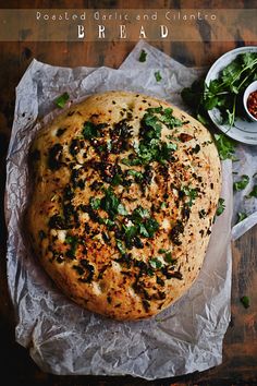 a pizza sitting on top of a piece of paper next to a bowl of salad