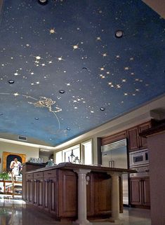 the ceiling is painted with stars and other things on it, as well as a kitchen island