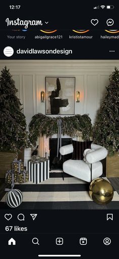 a living room decorated for christmas with white furniture and black and gold decor on the walls