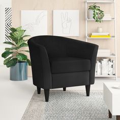 a blue chair sitting on top of a rug in a living room