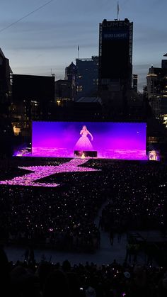 the stage is lit up with purple lights