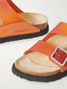 Find BIRKENSTOCK Arizona Milky Suede-trimmed Pvc Sandals on Editorialist. Birkenstock 1774's 'Arizona' sandals are a cult classic that have been reinvented countless times since they debuted over 50 years ago. This 'Milky' pair has suede-trimmed PVC straps and comfortable molded footbeds. Designer Summer Slides With Buckle Closure, Luxury Summer Footbed Sandals With Leather Sole, Orange Flat Sandals With Buckle Closure, Luxury Summer Sandals With Cushioned Footbed, Luxury Summer Footbed Sandals With Cushioned Footbed, Luxury Cushioned Footbed Sandals For Summer, Orange Buckle Closure Sandals For Vacation, Orange Sandals With Buckle Closure For Vacation, Orange Leather Sandals With Buckle Closure