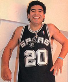 a man in a basketball uniform is smiling for the camera