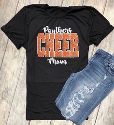 Cheer Team, Cheer Mom, Team Pride, School Spirit, Cheer Mom, Cheerleading Squad Shirt, School Colors, Tumbling, Dance, Unisex Fit Glitter Unisex Fit Tee (Shown in Black) Colors are customizable. Glitter Vinyl (Orange Glitter with matte white shown.) All materials used are high quality, professional grade. Please check shop updates for current turnaround times! Competition Cheer Shirts, Black Glitter Print Tops For Cheerleading, Black Glitter Print T-shirt For Cheerleading, Short Sleeve Glitter Print Top For Cheerleading, Short Sleeve Top With Glitter Print For Cheerleading, Team Spirit T-shirt With Glitter Print For Cheerleading, School Spirit Tops With Glitter Print For Cheerleading, Black Glitter Stretch Top, Black Stretch Top With Glitter