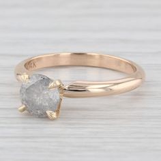 a gold ring with a white diamond in the middle