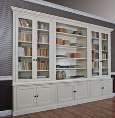 a large white bookcase with many books on it