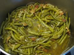 green beans are cooking in a pot on the stove