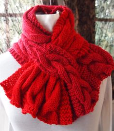 a red knitted scarf on top of a mannequin