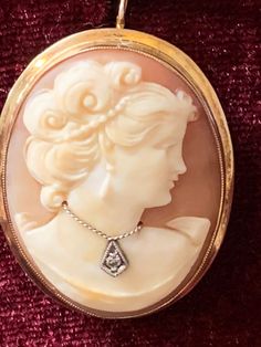 "Vintage Early DBA Budlong Docherty and Armstrong 14k gold Hand carved genuine shell cameo wearing a sinlge cut diamond necklace \"en habille\" brooch pin pendant  Gorgeous well detailed carved shell Cameo Brooch with hinged bail on the back so that it can be worn as a brooch or necklace.  measures 1 1/2\" x 1\"  This is set in a nice simple 14k yellow gold frame measures approx 5mm at the top and tapers to 2.5mm at the sides and back up to 5mm at the bottom  Diamond is approx 1.2mm Hallmarked DBA ( Budlong Docherty and Armstrong)\"14K\" on the fold over safety clasp.  Approx 6.4g  This will include a nice box Shipped priority and insured  Hand carved genuine shell cameo wearing a sinlge cut diamond chip necklace \"en habille\".  Please do note that all natural shell cameos when held to st Antique Cufflinks, Buying Gold, Vintage Fine Jewelry, Cameo Jewelry, Carved Shell, Heart Dangle Earrings, Gold Hand, Cameo Brooch, Pin Pendant