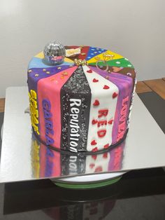 a multi - colored cake decorated with candy bars