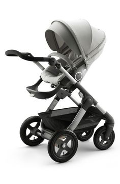 the stroller has two wheels and is white with black trims on it's sides