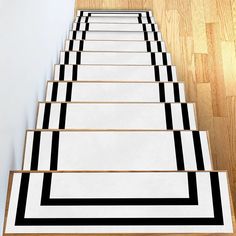 black and white rugs are lined up on the floor