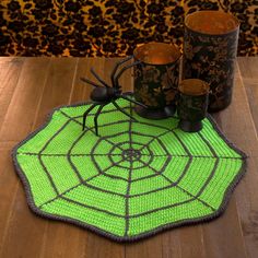 a green spider web rug with candles on it