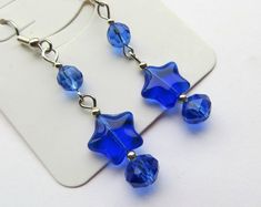 CJ's Inspirations "Royal Blue Stars" These beautiful earrings are made with sparkling crystal glass beads, Czech Star beads and silver plated spacers. These earrings are set with stainless steel french hook ear wires. They make a lovely addition to your wardrobe or a great gift for others. Additional ear wires are shown in the final photo and can be altered per request. There is a $1 fee for altering these to a clip earring style. Those are also nickel free for sensitive ears. Length: 2 inches l Blue Star Charm Earrings For Party, Dangle Beaded Earrings, Bead Inspiration, Star Beads, Bead Ideas, Blue Stars, Wire Earrings, Sparkling Crystal, Beaded Dangles