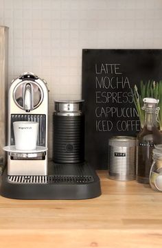 a coffee maker sitting on top of a wooden counter