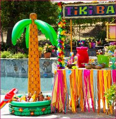 there is a palm tree decorated with streamers in the pool and decorations around it