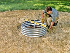 a man working on a well in the ground