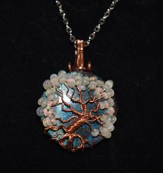 Tree of Life pendant made with a Shattukite stone in the center, and wrapped in copper wire . 52 welo opal beads added to the tree's branches. Spiritual Wire Wrapped Opal Jewelry, Spiritual Wire-wrapped Opal Jewelry, Bohemian Wire Wrapped Opal Jewelry, Bohemian Opal Jewelry Wire Wrapped, Bohemian Opal Wire Wrapped Jewelry, Unique Hand Wrapped Opal Jewelry, Unique Opal Wire Wrapped Jewelry, Wire Wrapped Opal Pendant Necklace, Handmade Pink Opal Spiritual Jewelry