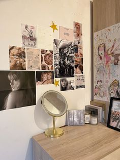 a desk with a mirror and pictures on the wall