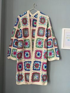 Granny Square Cardigan, Marbled Knit Coat, Retro Vintage Jacket, Clear Blue Cardigan, Pink Boho Long Cardigan, Moms for Gift, Gift for Her, XMAS, Women 🧥It is my pleasure to be offering this awesome fashion multicolor crochet jacket. This coat is perfect for four seasons, ANYWHERE, ANYTIME. The cardigan looks very nice with dress, with jeans and with any other clothing. You can use at home, at work, and outside as you wish for many years. MEASUREMENTS The measurement table is at the end of the Bohemian White Outerwear With Granny Square Details, Bohemian White Outerwear With Granny Square, Blue Granny Square Cardigan For Fall, White Bohemian Patterns For Winter, Blue Crochet Cardigan For Winter, Handmade Long Cardigan For Winter, Blue Crochet Winter Cardigan, Vintage Multicolor Granny Square Outerwear, Bohemian Knitted Cotton Outerwear