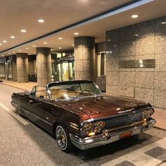 an old car parked in front of a building