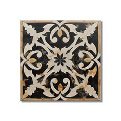 a black and white tile with an intricate design on the back side, in square shape