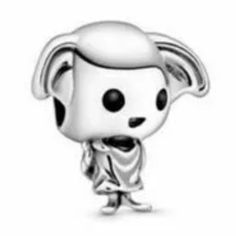 a silver figurine with black and white dots on it's face, wearing a