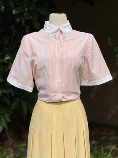 Vintage Multi Pastel Colored Striped Button-Up Collared Short Sleeve Blouse  -Velcro Collar -Solid white trim -Colors: White, pink, blue, yellow  No marked size. Please go by measurements. Measurements (laid flat, not doubled): Shoulder to shoulder: 16" Underarm to underarm: 23" Hem across: 24" Full length: 26" Condition: Excellent! Daywear Button-up Blouse With Striped Collar, Fitted Button-up Top With Contrast Collar, Fitted Tops With Contrast Collar And Button-up, Spring White Blouse With Striped Collar, Fitted Short Sleeve Preppy Blouse, Daywear Blouse With Striped Collar And Button-up Shape, White Blouse With Striped Collar For Spring, White Striped Collar Button-up Blouse, White Button-up Blouse With Striped Collar