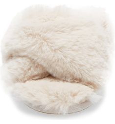 a white furry hat is shown on a white background